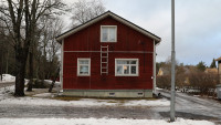 Gable of a small red wooden house.