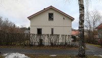 Gable of a small white wooden house.